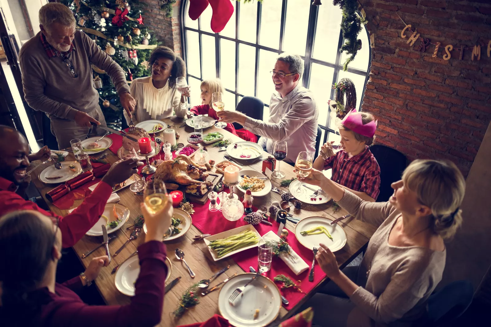 Family laughing together during a festive Christmas celebration at home